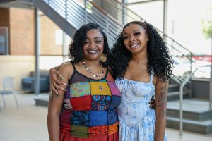 mother and daughter standing next to each other in school