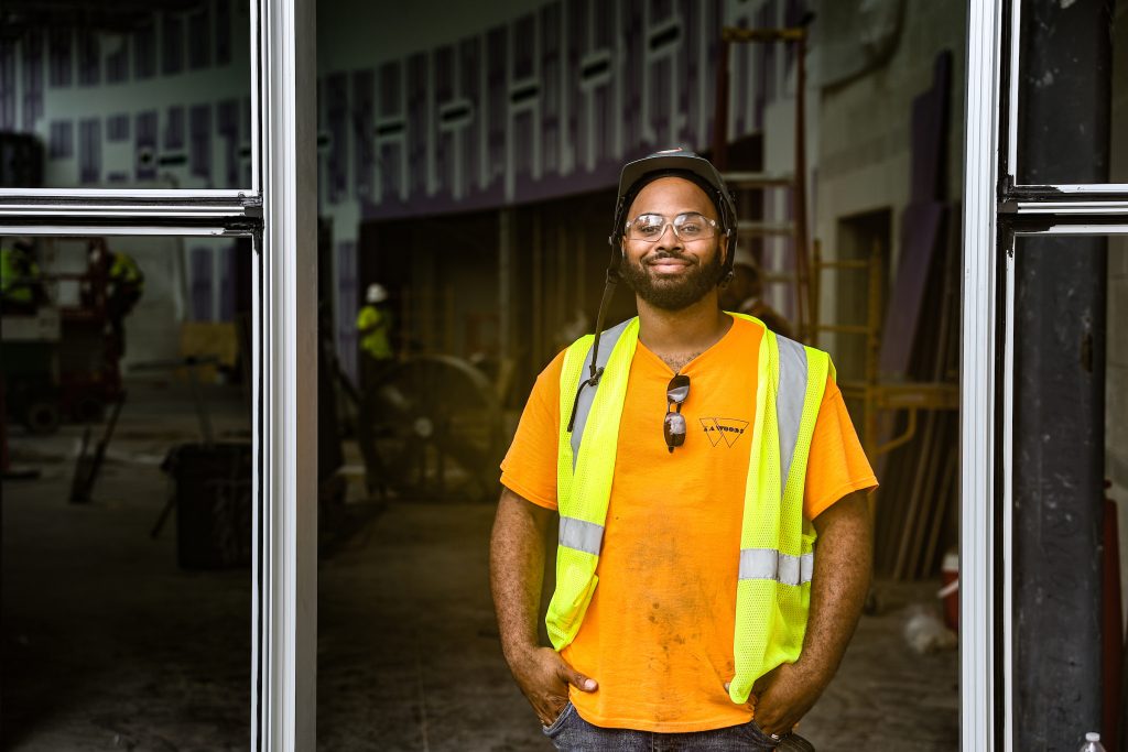 plumber standing in front of construction site