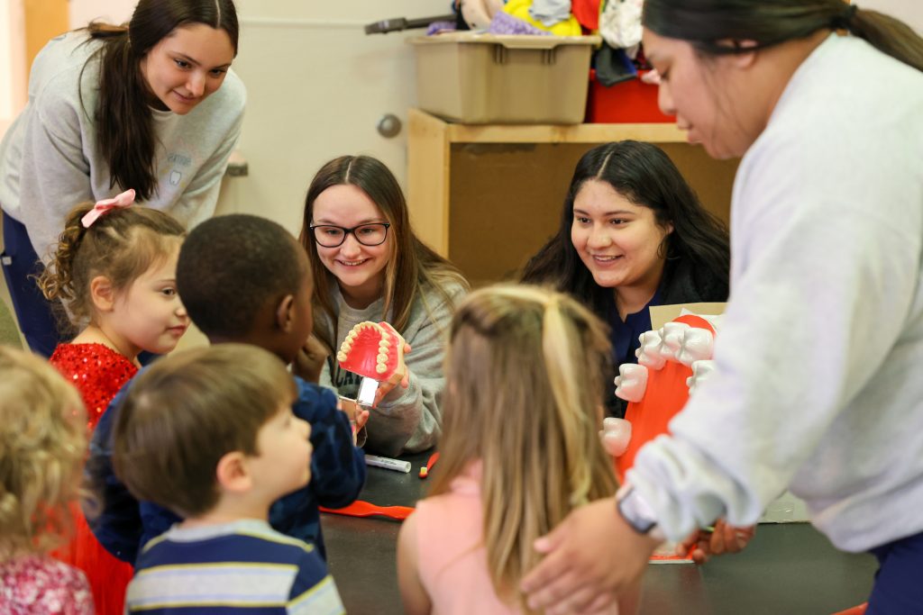 dental assisting students teaching kids about dental health