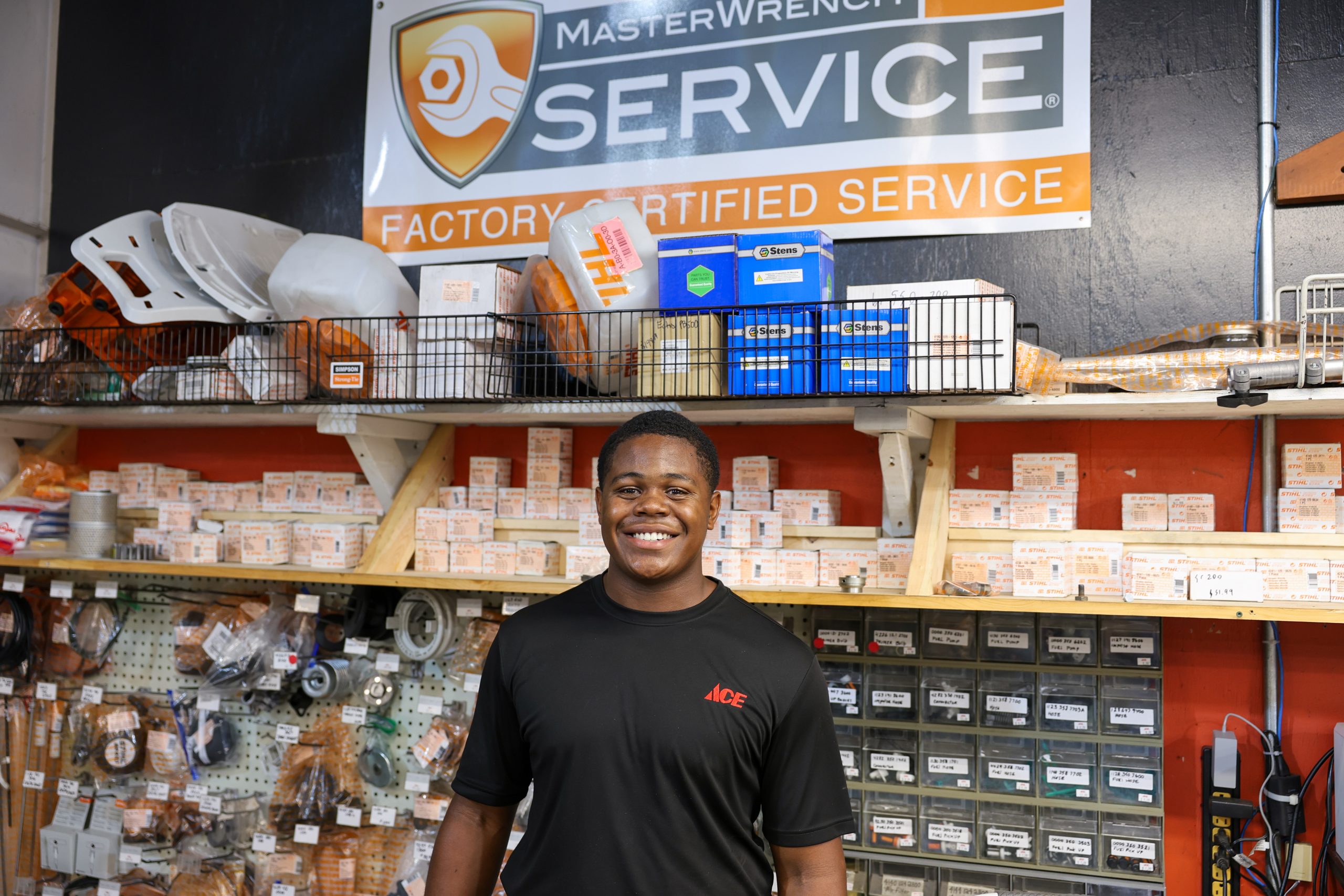 Ace employee standing behind parts