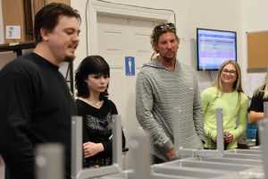 teacher and students getting tour of beach mule