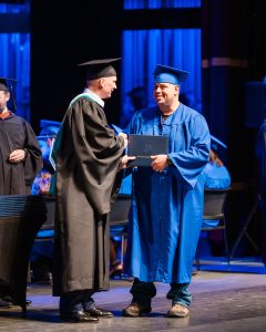graduate accepting diploma from president