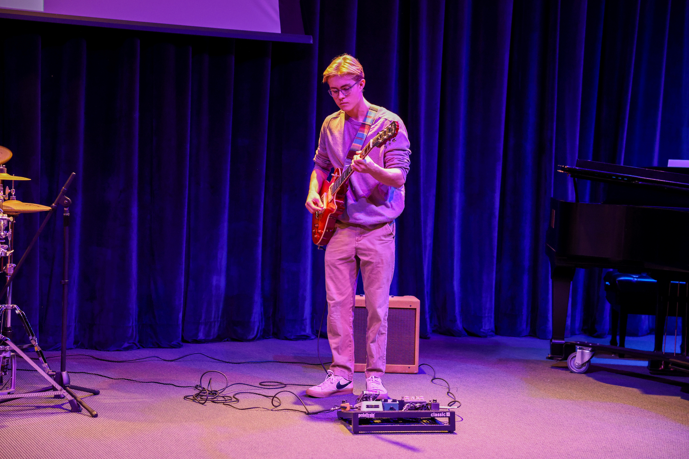 student playing electric guitar