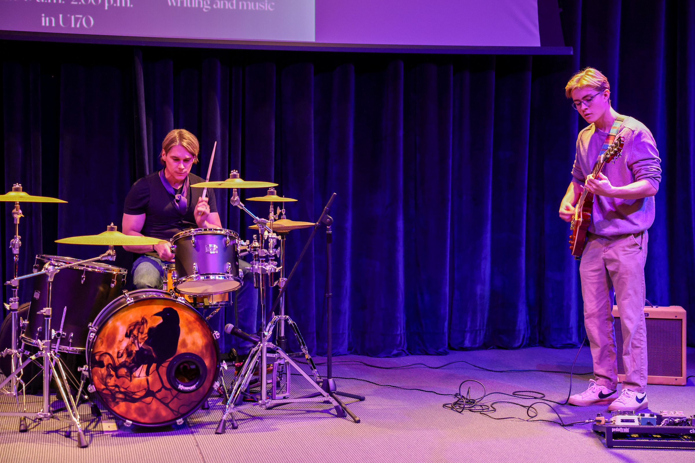 miles playing guitar and dr j playing drums
