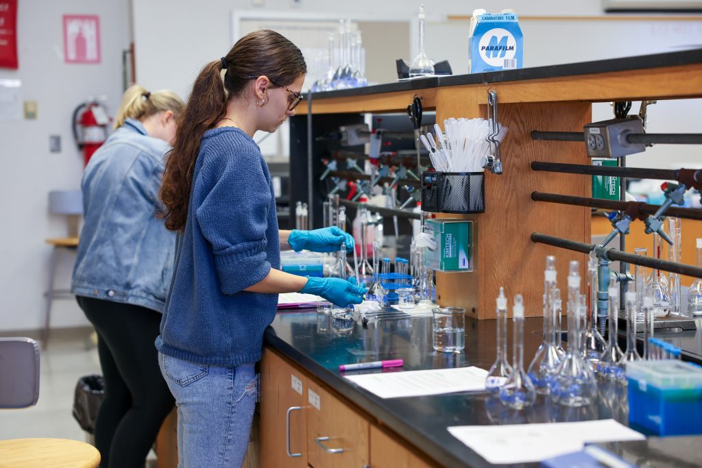 Female student working in chemical technology laboratory. 