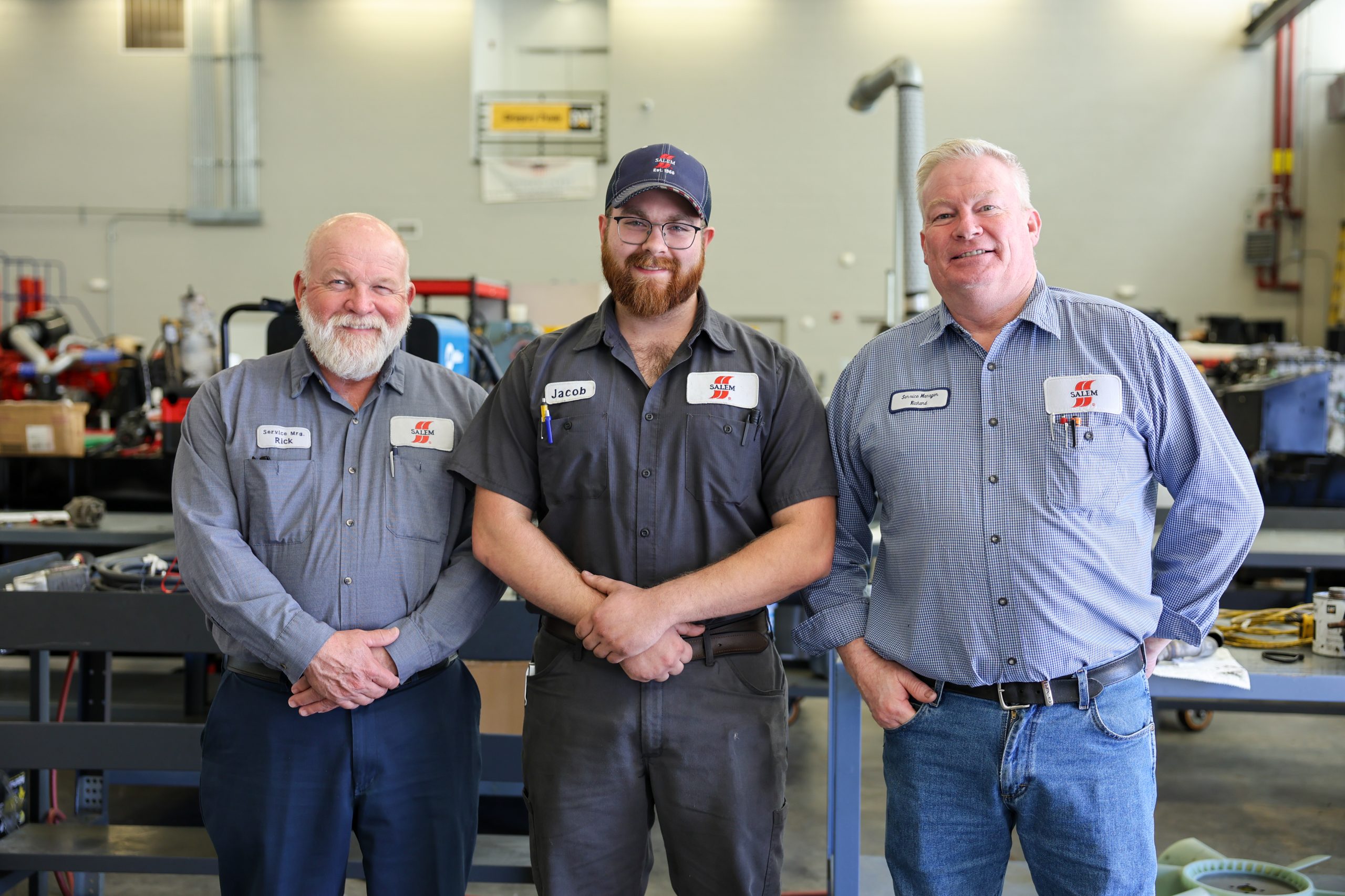 Jacob freeland with two salem employees in diesel shop