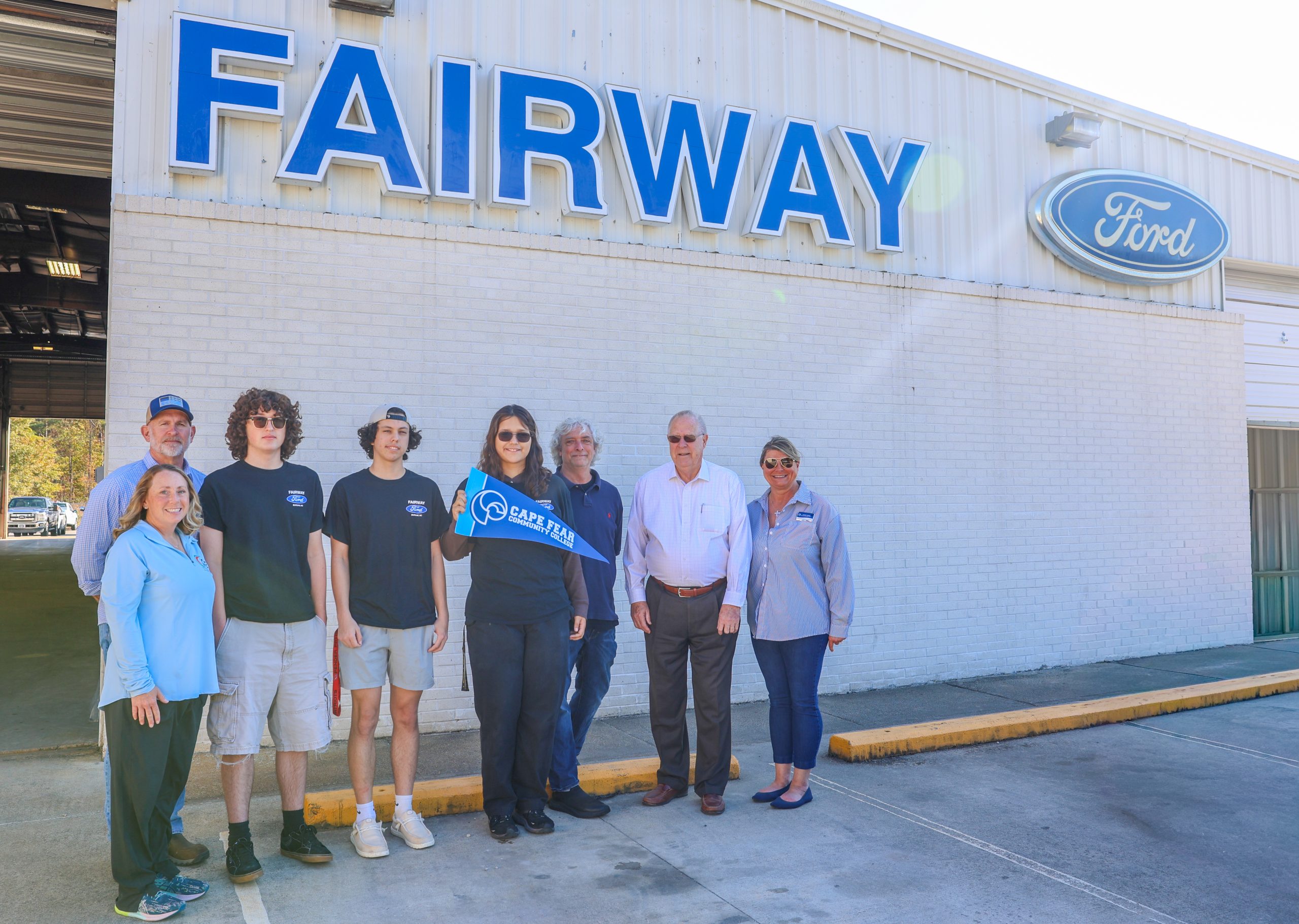 large group in front of fairway ford dealership