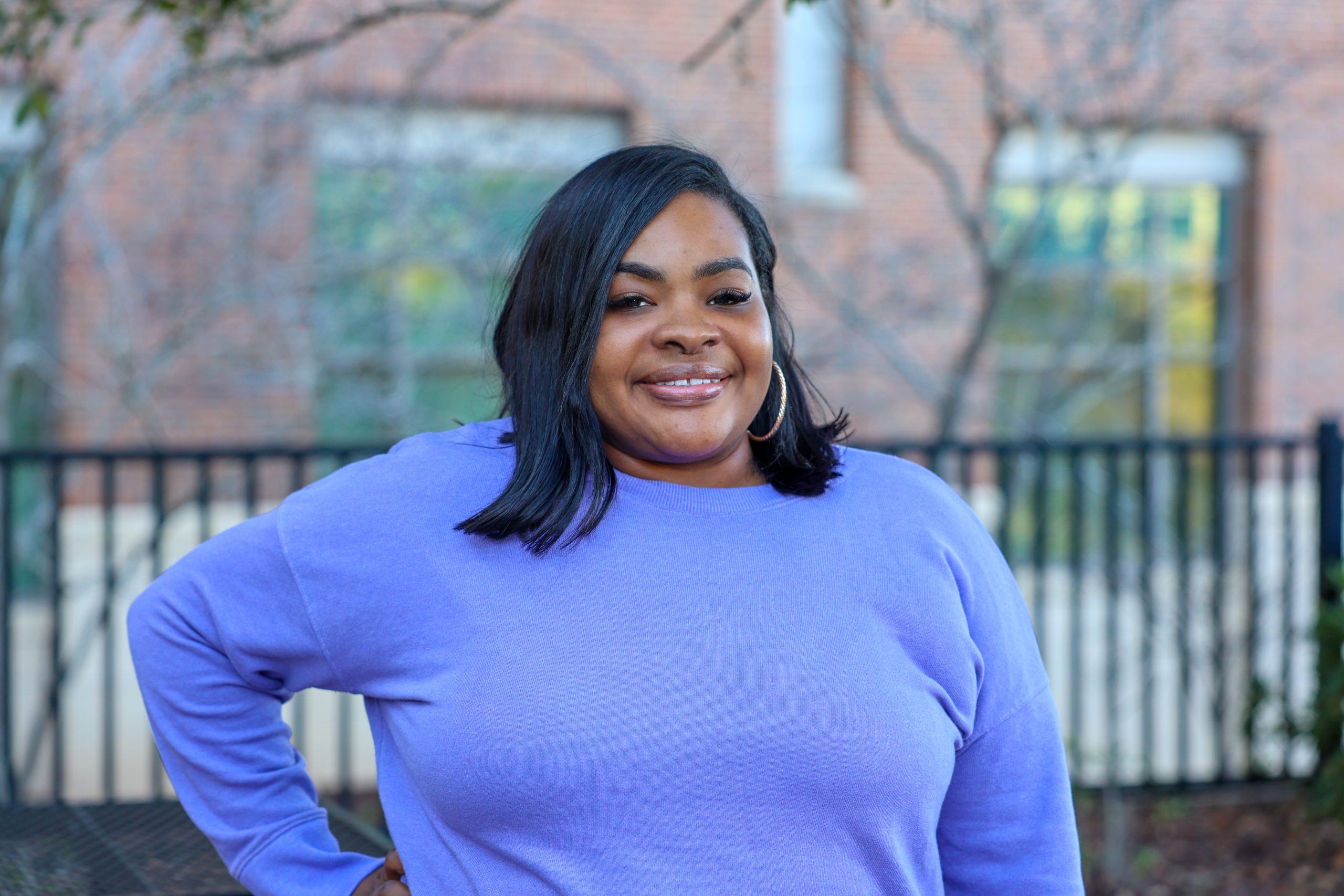 female posing for camera outside of campus