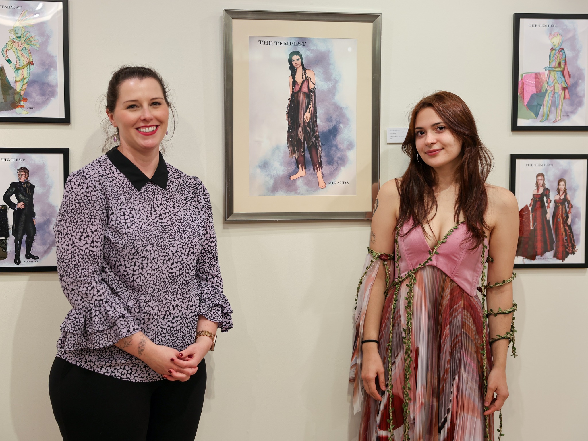 theatre instructor and student standing in front of framed art picture