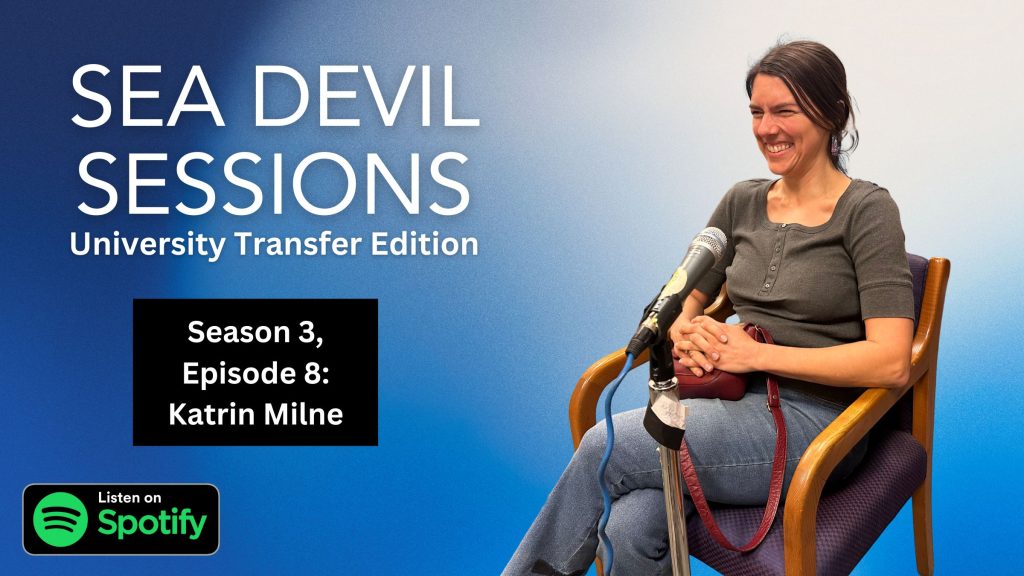 Promotional graphic for the “Sea Devil Sessions – University Transfer Edition” podcast featuring Season 3, Episode 8 with Katrin Milne. The image shows a smiling woman seated in a chair against a blue background, speaking into a microphone on a stand. Text on the left reads “Sea Devil Sessions – University Transfer Edition” and “Season 3, Episode 8: Katrin Milne,” with a “Listen on Spotify” logo at the bottom.