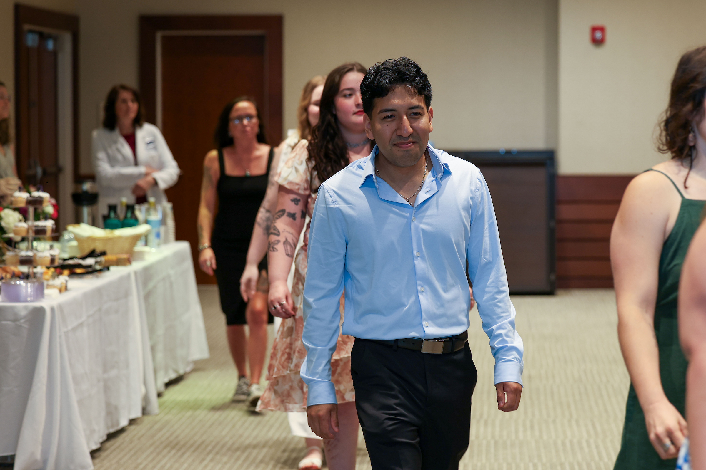 student walking into pinning ceremony