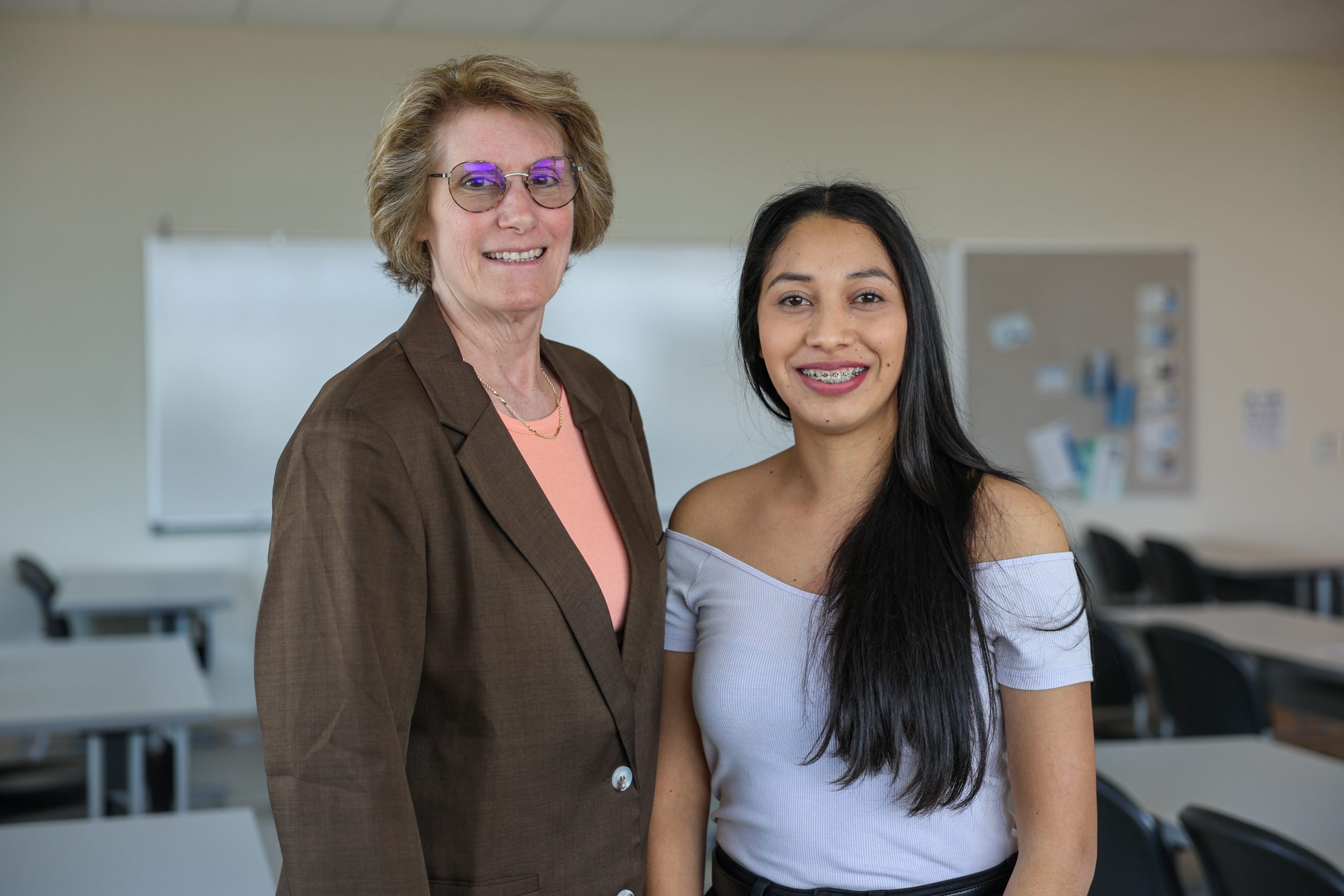 student and faculty member standing next to each other