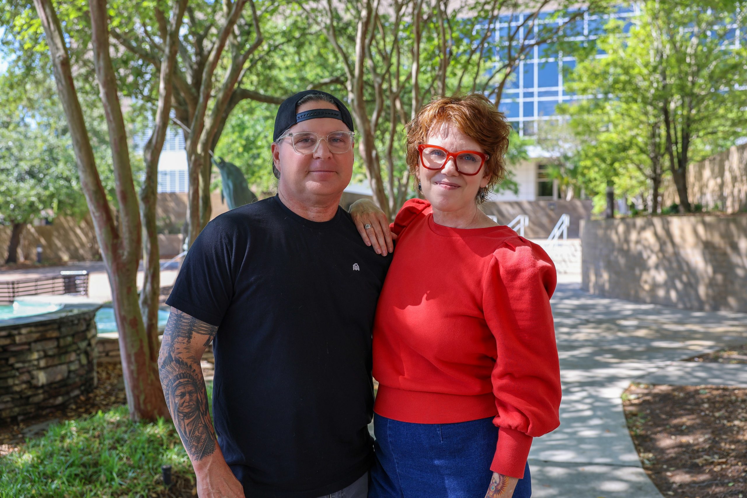 couple smiling outside on campus