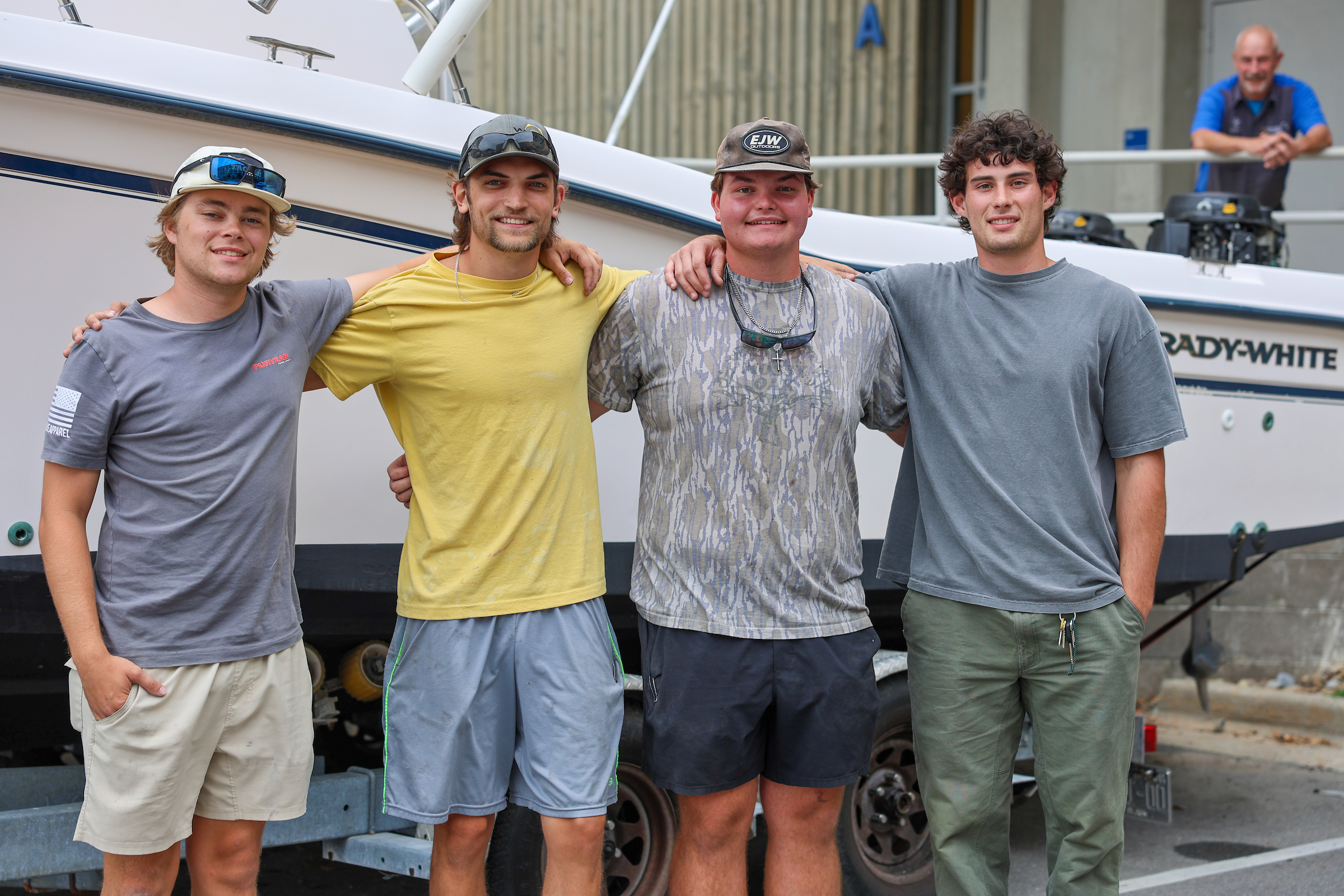 group of students behind a boat