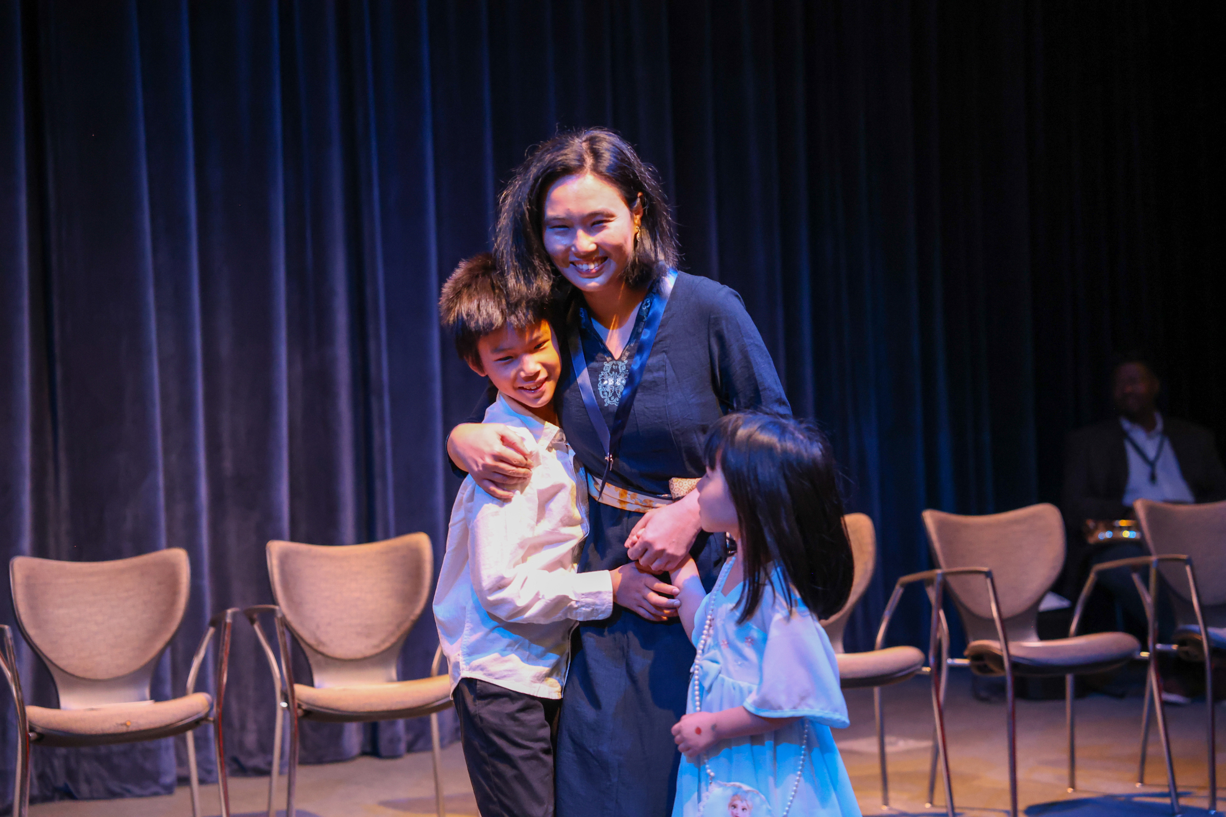 student embracing her children at pinning ceremony