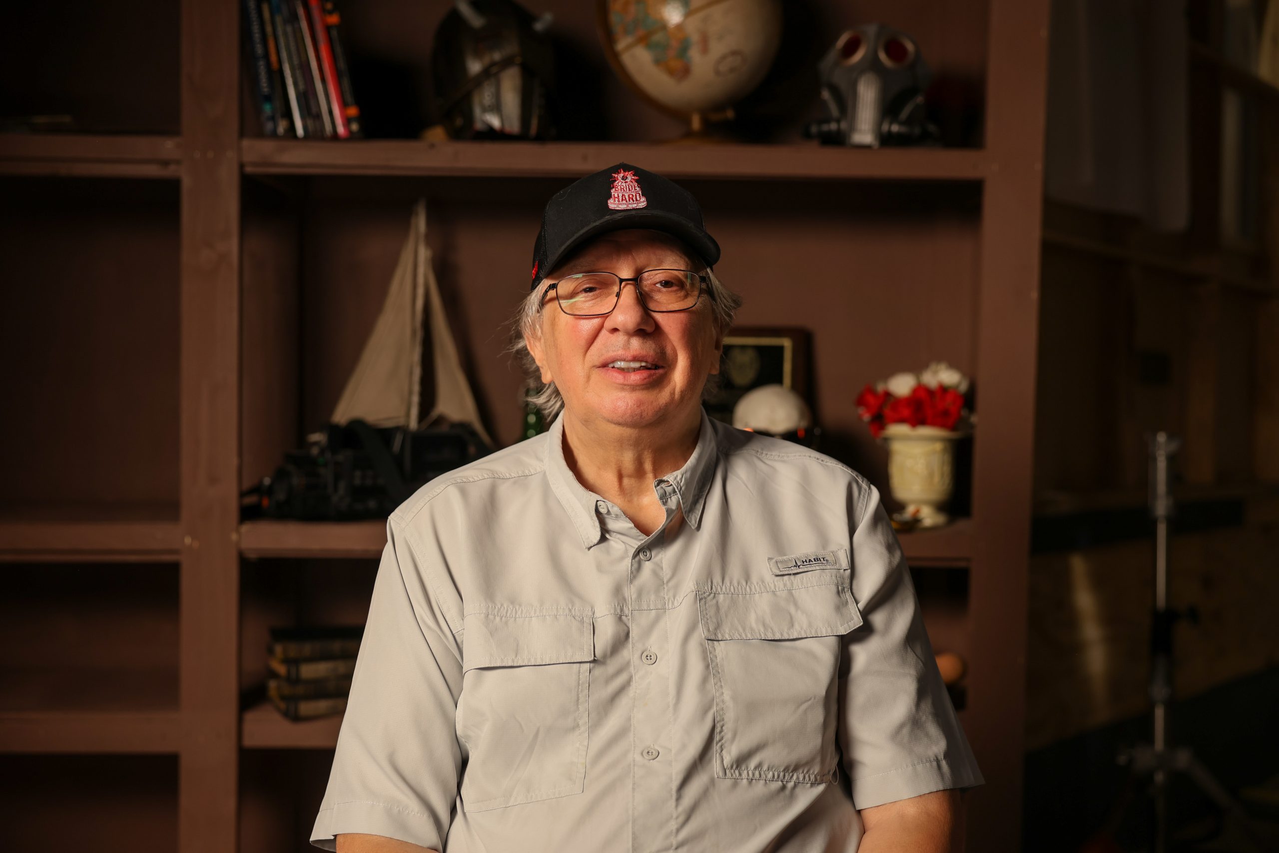 Male sitting in front of bookshelves