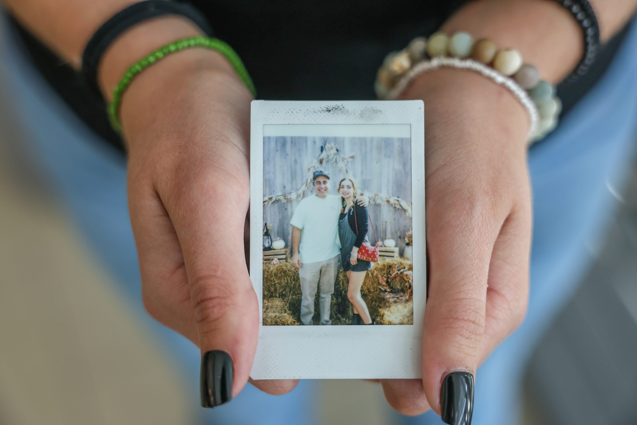 student holding picture of her and her father