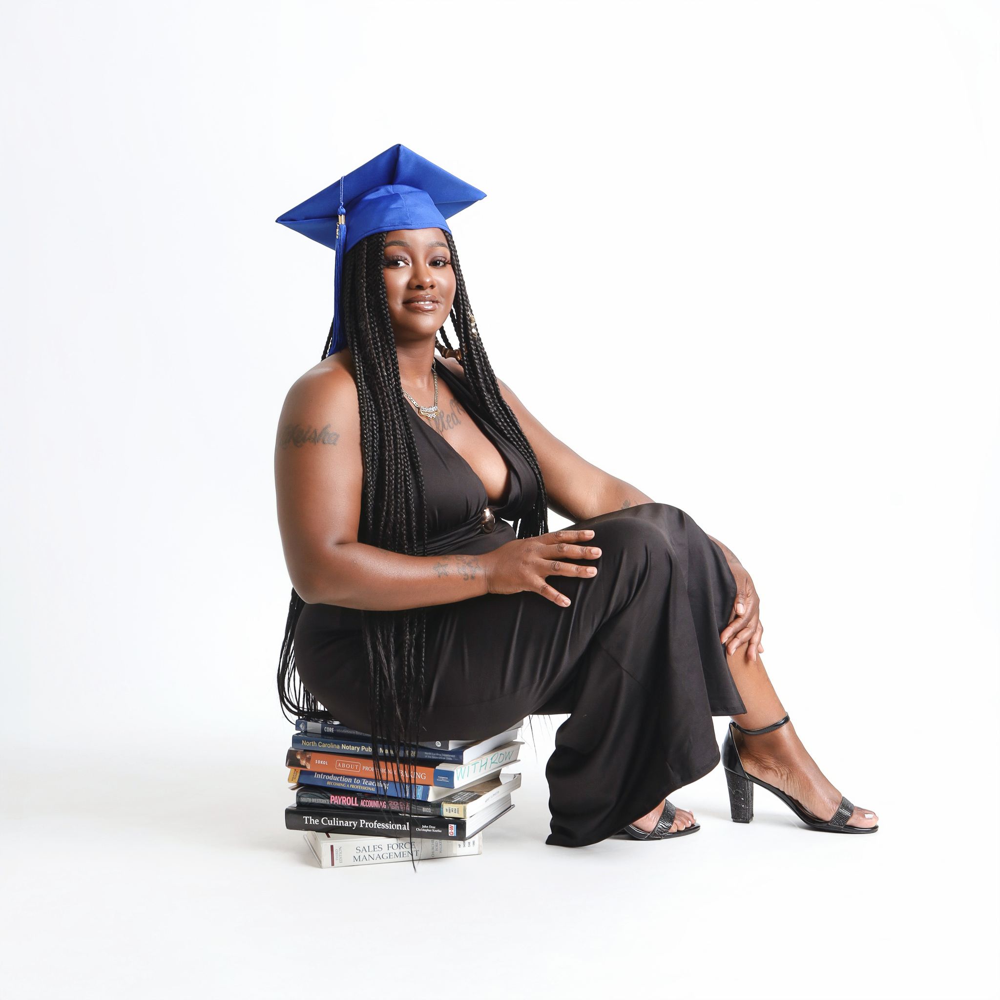 Lakeisha sitting on top of books