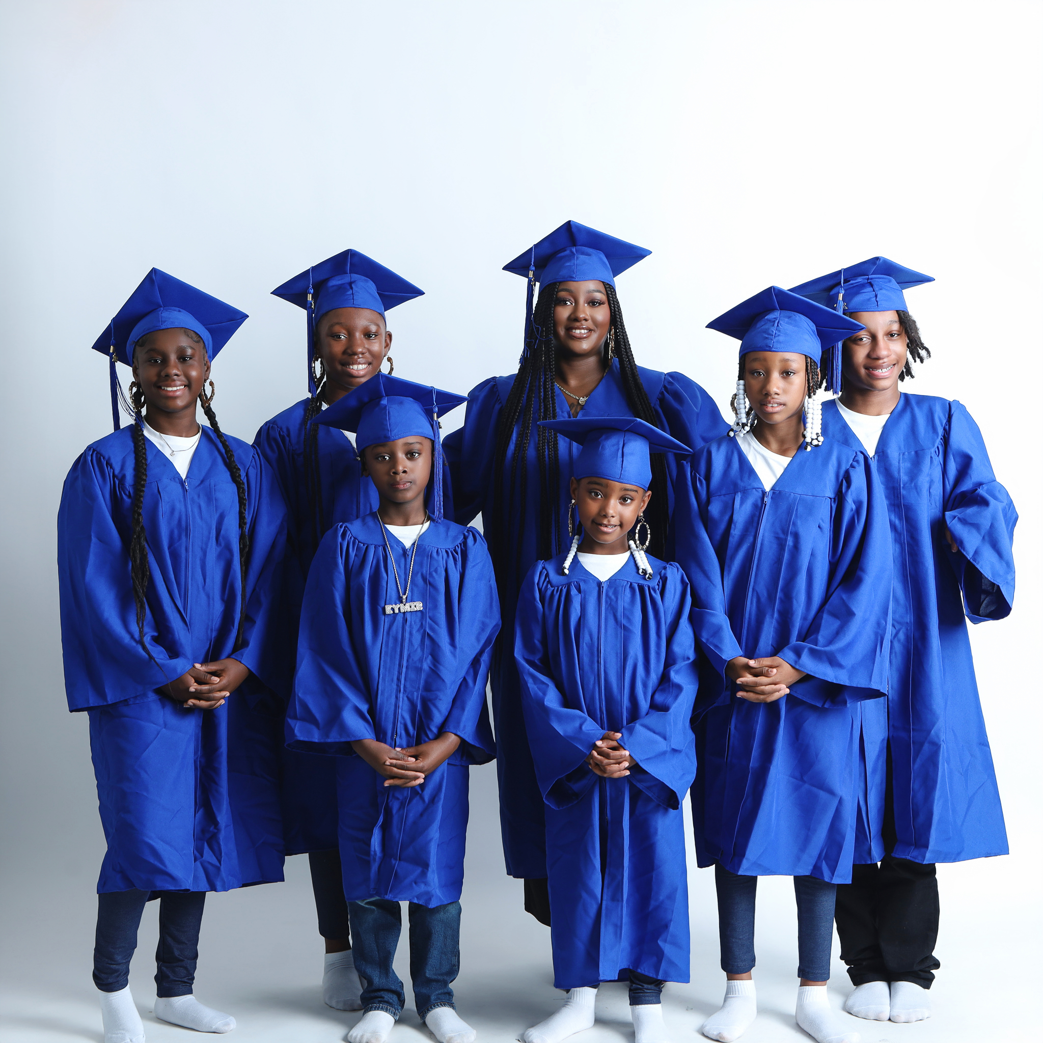 Lakeisha with her six children all wearing caps and gowns