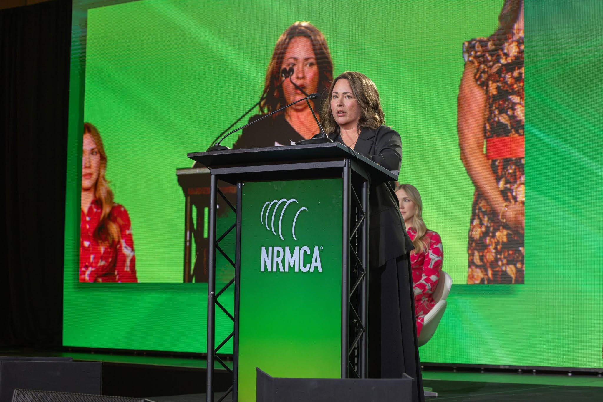 Jessica speaking at podium