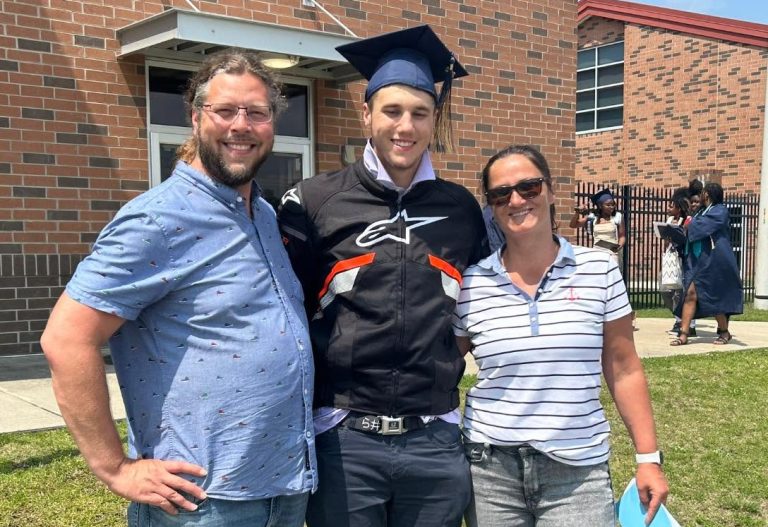Niki with his mom and dad at graduation